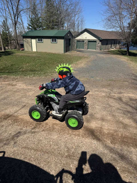 Racing the tractor :-)  He looks fast at least.  I stood on it and did a circle around him.  LOL.  I never let em win... they need to learn to lose :-)