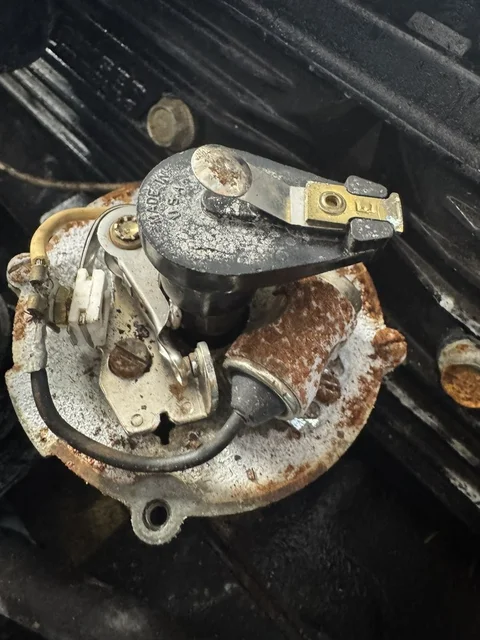 Points and Condenser... yeah, not happening.  Electronic ignition only.  Cheap upgrade, zero maintenance.  It's this or filing down points in the middle of the lake.